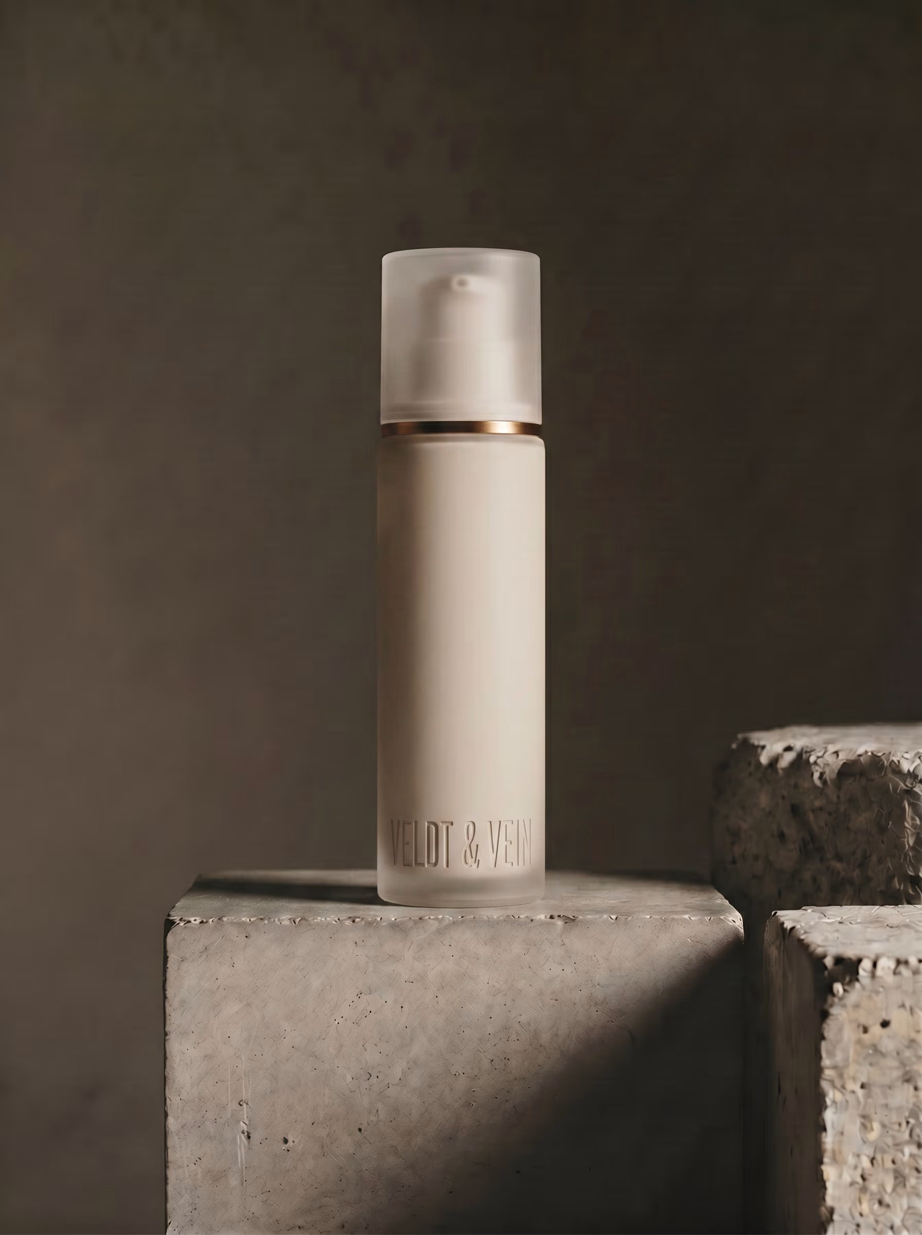 The Marula+Peptide Firming Body Serum dropper bottle — frosted glass, beechwood collar, black pipette.