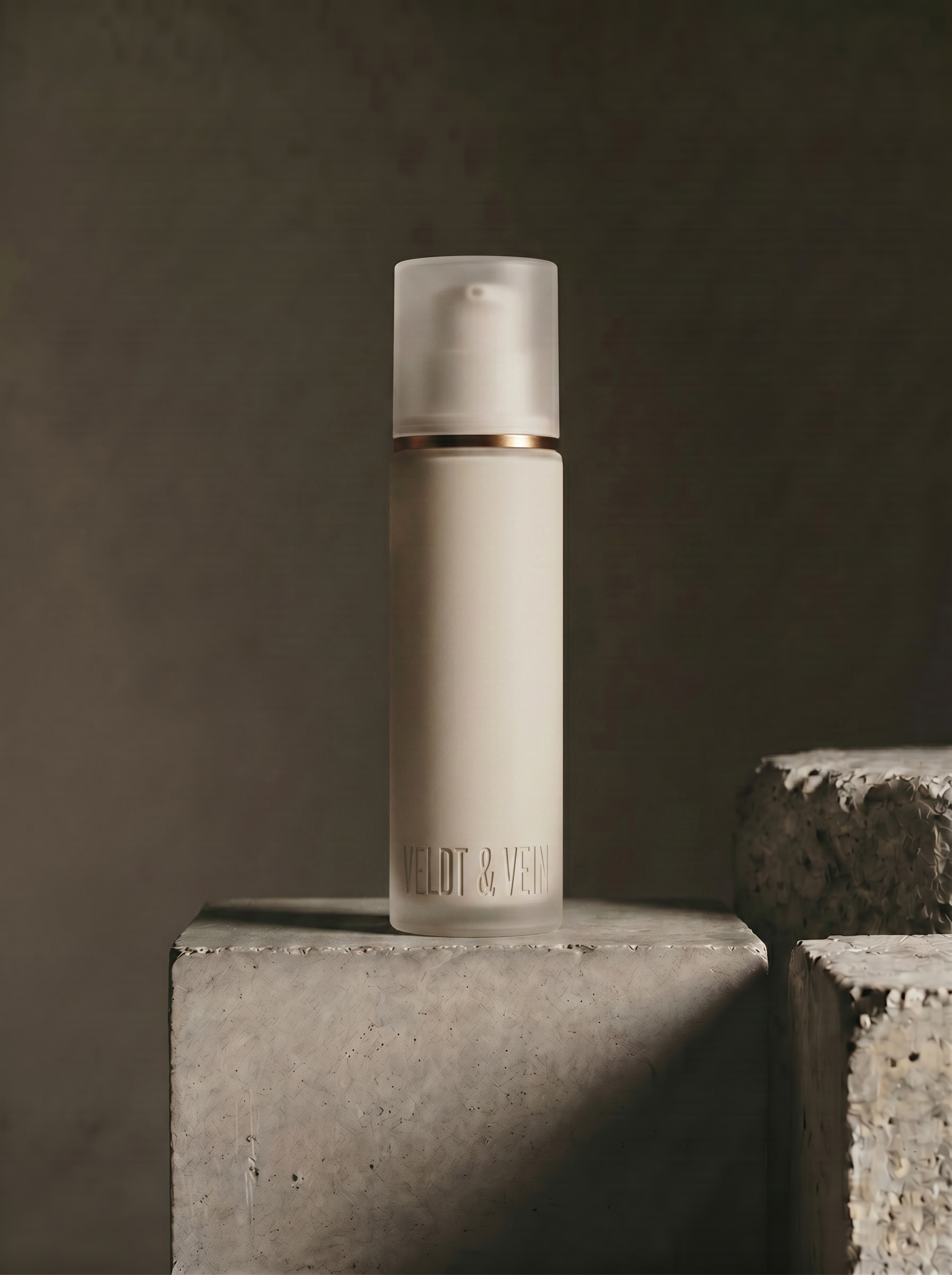 The Marula+Peptide Firming Body Serum dropper bottle — frosted glass, beechwood collar, black pipette.