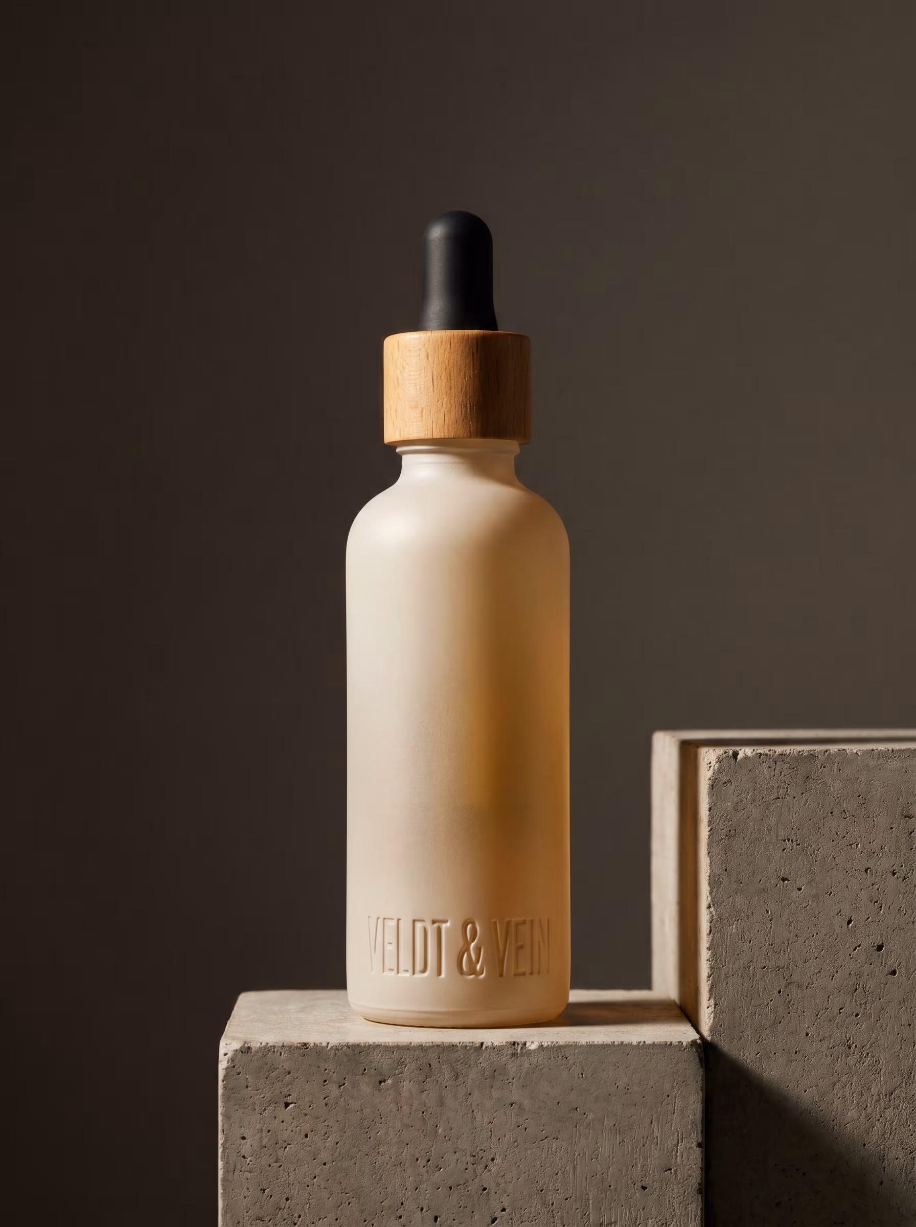 The Fynbos Sensorial Bath Oil — frosted glass bottle with beechwood-and-cork stopper.